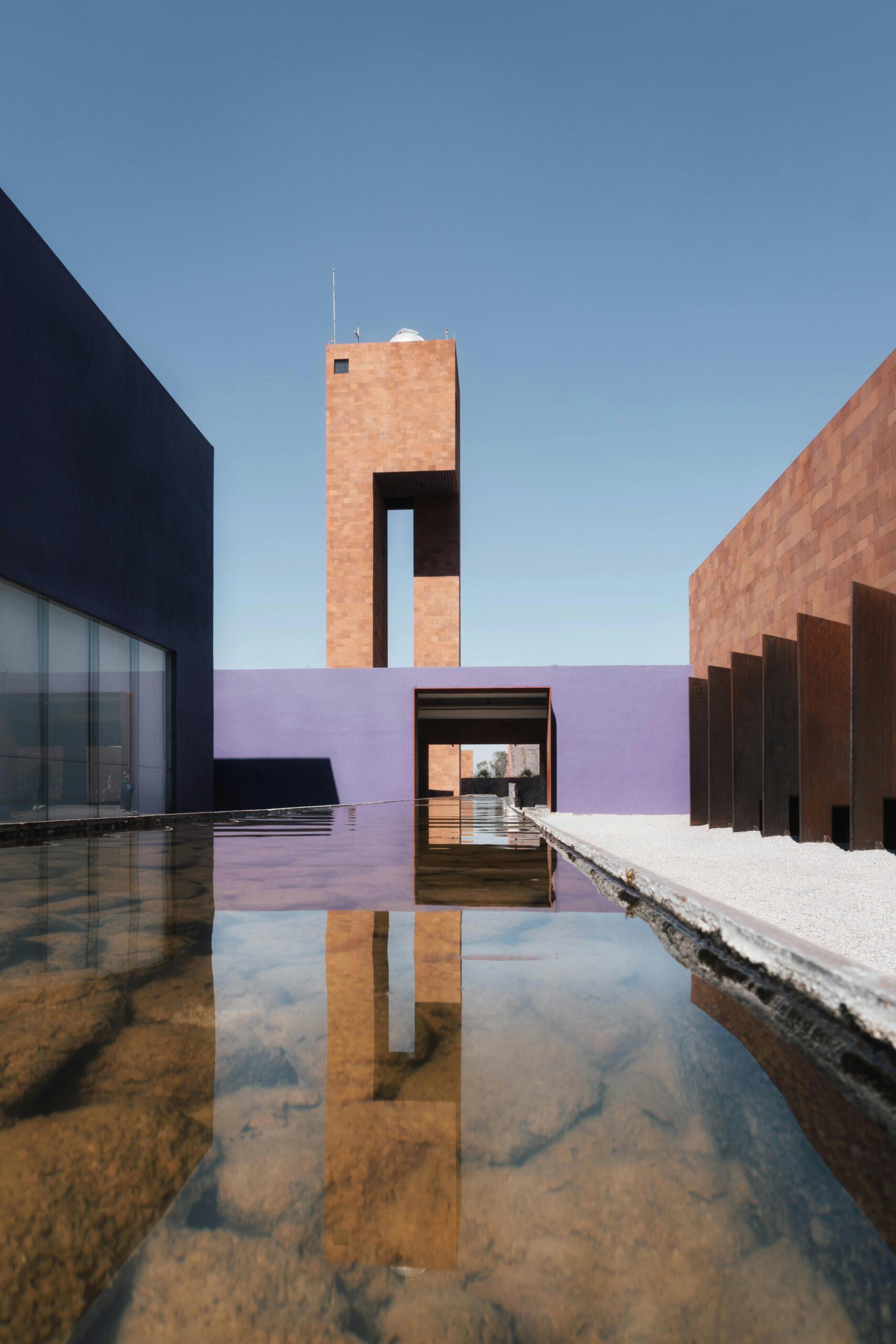 Elegant modern architecture reflected in calm water at a renowned museum.